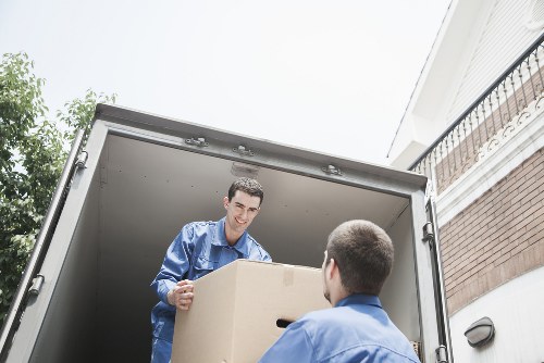 Local movers handling furniture in a Wallington street