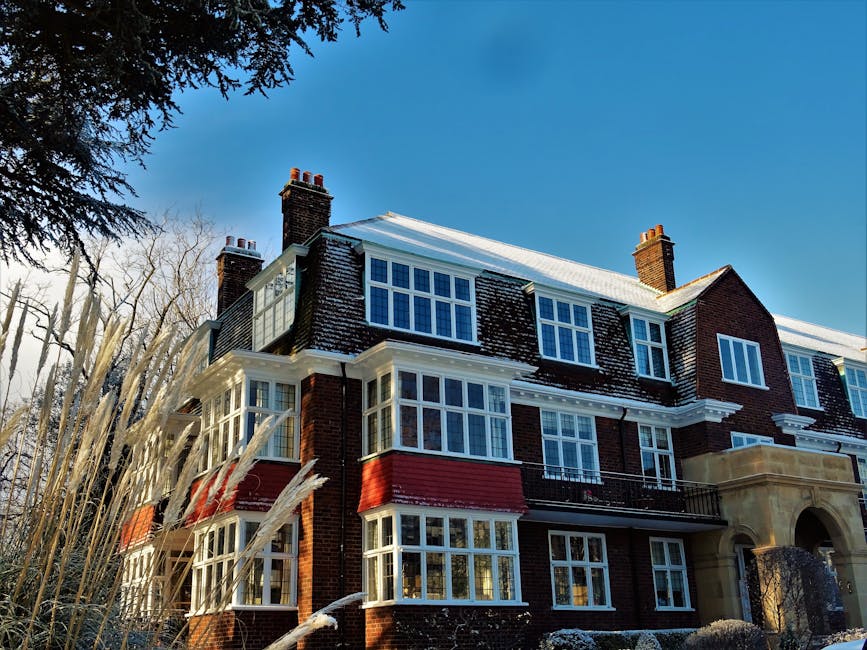 The image displays a shield-shaped emblem with a metallic silver and blue design featuring a white banner across the middle bearing the word 'INSURANCE'. The shield is set against a pale yellow background. While the image does not depict actual house removals or moving equipment, it visually suggests protection and security, which are key aspects when considering insurance and liability during home relocation processes. The shield's design and branding elements align with services offered by Man with Van Wallington, a company specialising in removals and house moves in the Wallington area. This visual is relevant within the context of insurance coverage for furniture transport, packing materials, and moving logistics, illustrating the importance of safeguarding belongings during the comprehensive home relocation process.